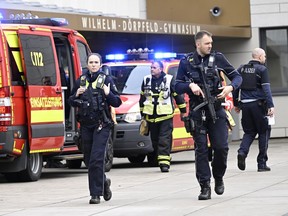 Police and ambulances at the scene of an attack, at the Wilhelm Dorpfeld school, in Wuppertal, Germany, Thursday, Feb. 22, 2024.