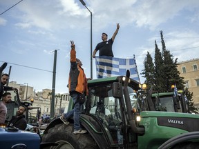 Greek farmers take part in a protest to demand financial aid in front of the Parliament in Athens on Feb. 20, 2024.