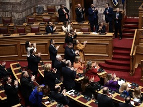 Members of the Greek government applaud during voting parliament on same-sex marriage in Athens, on Feb. 15, 2024.