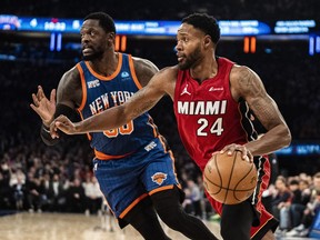 Miami Heat forward Haywood Highsmith (24) drives to the basket past New York Knicks forward Julius Randle, left, during the first half of an NBA basketball game on Saturday, Jan. 27, 2024, in New York.