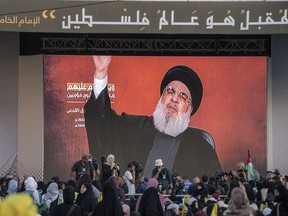 People in Beirut watch a speech by Hassan Nasrallah