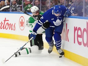 Dallas Stars forward Mason Marchment (27) checks Toronto Maple Leafs defenceman Simon Benoit.
