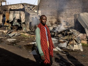 A man walks in front of some heavily damaged houses and shops in the area where he lives, the day after a gas explosion created severe damages in the Embakasi area of Nairobi on Feb. 2, 2024.