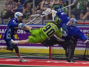 Saskatchewan Rush forward Ben McIntosh dives past Rochester Knighthawks defense Eric Shewell to score on goalie Matt Vinc in the forth quarter of game three of the National Lacrosse League finals in Saskatoon on Saturday, June 9, 2018. The National Lacrosse League is returning to the nation's capital, with the New York Riptide moving north of the border.