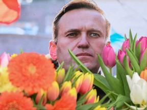 Flowers are seen placed around portraits of late Russian opposition leader Alexei Navalny, who died in a Russian Arctic prison, at a makeshift memorial in front of the former Russian consulate in Frankfurt am Main, western Germany, on Feb. 20, 2024.