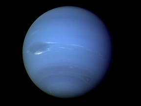 This August 1989 image provided by NASA shows the planet Neptune photographed by the Voyager 2 spacecraft, processed to enhance the visibility of small features. The International Astronomical Union's Minor Planet Center announced Friday , Feb. 23, 2024, that astronomers have found three previously unknown moons in our solar system -- two additional moons circling Neptune and one around Uranus. (NASA via AP)
