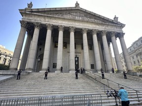 Law enforcement stand outside the New York State Supreme Court