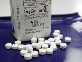 FILE - In this Feb. 19, 2013 file photo, OxyContin pills are arranged for a photo at a pharmacy in Montpelier, Vt. Companies and U.S. government entities have agreed to settlements of lawsuits over the toll of opioids totaling more than $50 billion.