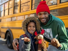 Bus driver Larry Farrish Jr., right, with Levi outside Engelhard Elementary School earlier this month.