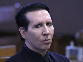 FILE - Musical artist Marilyn Manson, whose legal name is Brian Hugh Warner, waits for the judge to arrive in Belknap Superior Court,Monday, Sept. 18, 2023, in Laconia, N.H. Manson, who was sentenced to community service for blowing his nose on a videographer at a 2019 concert in New Hampshire, recently completed his time at an organization that provides meeting space for Alcoholics Anonymous and Al-Anon, according to court paperwork.