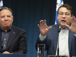 Bernard Drainville, Quebec Minister of Education. speaks to the press alongside Quebec Premiere Francois Legault during a press conference in Montreal, Sunday, Feb. 18, 2024.