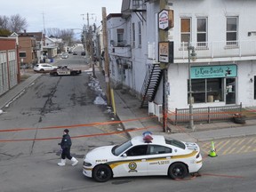 A coroner's inquiry is set to begin into the killing of a Quebec provincial police officer last March and her assailant who was killed by her colleagues. Police tape cordons off the scene after a Quebec provincial police officer was killed while trying to arrest a man in Louiseville, Que., Tuesday, March 28, 2023.