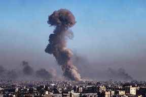 A picture taken from Rafah shows smoke billowing during Israeli bombardment over Khan Yunis in the southern Gaza Strip on Feb. 11, 2024, amid the ongoing conflict between Israel and the Palestinian Hamas militant group.