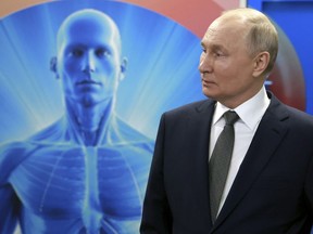 Russian President Vladimir Putin listens