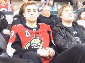 Embarrassed boy after getting caught rapping to Eminem on camera at hockey game.
