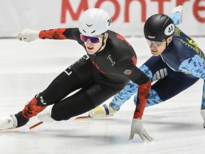 Felix Roussel (24) skates ahead of Yerkebulan Shamukhanov of Kazakhstan during the 1,500-metre repechage semifinal race at the World Cup short track speedskating event in Montreal, Saturday, Oct. 28, 2023.