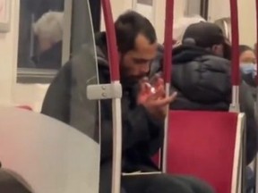 Man smoking what appears to be a crack pipe on TTC subway train.