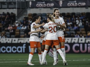Canada captain Jessie Fleming (left), Cloe Lacasse and Jordyn Huitema (right) celebrate a goal in Canada's 6-0 win over El Salvador in CONCACAF W Gold Cup soccer action in Houston in this Thursday, Feb. 22, 2024 handout photo.