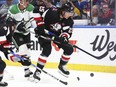 Buffalo Sabres defenseman Owen Power (25) carries the puck behind the net during the first period of the team's NHL hockey game against the Dallas Stars on Tuesday, Feb. 6, 2024, in Buffalo, N.Y.