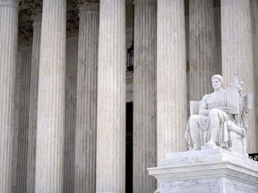 The Guardian of Law scuplture is seen at the west entrance of the Supreme Court on Thursday, Feb. 22, 2024, in Washington.