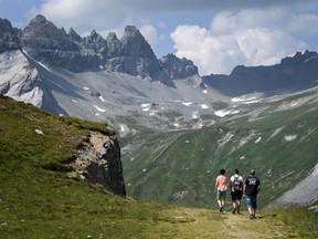 Hikers walk in the Swiss mountains
