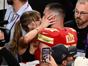 Taylor Swift and Travis Kelce kiss after Super Bowl win. Getty