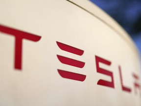 The logo for the Tesla Supercharger station is seen