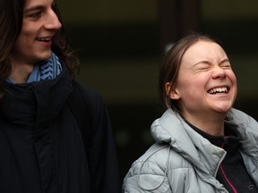 Swedish environmental activist Greta Thunberg and fellow defendant Christofer 'Chris' Kebbon (left) return to Westminster Magistrates Court in London on Feb. 2, 2024, on the second day of their public order offence trial.