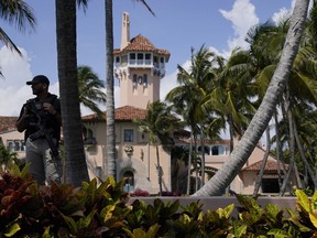 A security guard stands on the perimeter of Mar-a-Lago