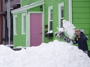 A person shovels snow in Halifax on Monday, February 5, 2024.&ampnbsp;Cleanup in Nova Scotia could take days after more than a metre of snow piled up in some parts of the province over the weekend.