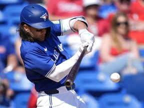 Toronto Blue Jays' Bo Bichette hits a single in the fifth inning of a spring training game against the Philadelphia Phillies.