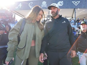 Paulina Gretzky and Dustin Johnson hold hands at an event.