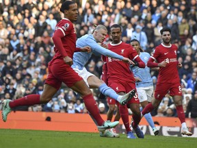 Manchester City's Erling Haaland scores his side's opening goal during the against Liverpool.