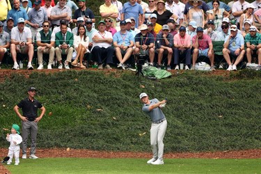 Mackenzie Hughes plays his shot from the ninth tee during the Par 3 contest prior to the 2023 Masters Tournament.