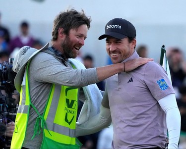 Nick Taylorcelebrates with caddie Dave Markle after defeating Charley Hoffman on the second playoff hole at the 18th green during the Phoenix Open.