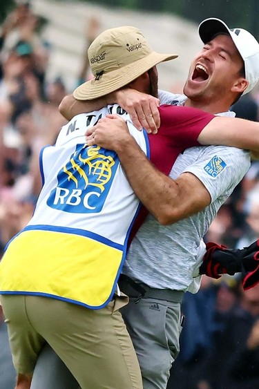 Nick Taylor celebrates with his caddie after making an eagle putt to win the RBC Canadian Open.