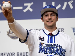 Trevor Bauer wears the uniform and cap of Yokohama DeNA BayStars last year.