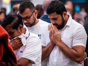Dhanushka Wickramasinghe (right), the father of the four children and husband to their mother who died, was able to attend Sunday's memorial ceremony, despite being seriously hurt in the march 6 attack that killed six.