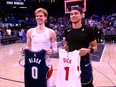 Raptors' Gradey Dick and Orlando Magic rookie Anthony Black hold each other's jerseys after Sunday's game.