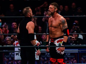 Adam Copeland (right) faces off with Christian Cage in an AEW ring.