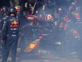 Red Bull Racing's Max Verstappen gets out of his smoking car after retiring during the Australian Formula One Grand Prix.