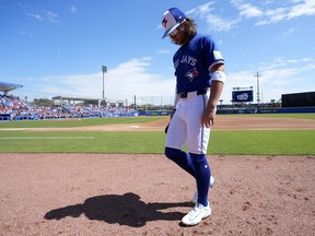 Toronto Blue Jays shortstop Bo Bichette walks to the duout before a spring training baseball game.