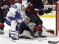 Toronto Maple Leafs' Pontus Holmberg and Carolina Hurricanes goaltender Frederik Andersen battle for control of the puck.