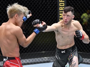 Julian Erosa punches Seungwoo Choi of South Korea in a UFC featherweight bout in 2021.