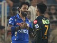 Gujarat Titans' captain Shubman Gill is congratulated by Mumbai Indians' captain Hardik Pandya.