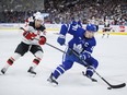 Toronto Maple Leafs centre John Tavares (91) skates the puck by New Jersey Devils centre Nico Hischier.