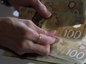 Canadian $100 bills are counted.