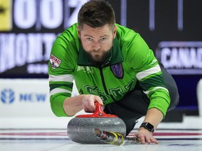 Saskatchewan skip Mike McEwen delivers a rock while playing Team Alberta-Koe during the Brier, in Regina, on Sunday, March 3, 2024.