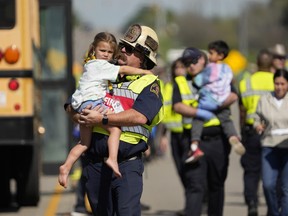 Children are transported from a fatal school bus crash on Texas State Highway 21 near Caldwell Road on Friday, March 22, 2024, in Bastrop, Texas.