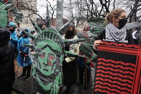 People participate during a rain storm in a demonstration and march to demand that Israel end its war in Gaza and agree to a cease-fire on March 02, 2024 in New York City. (Photo by Spencer Platt/Getty Images)